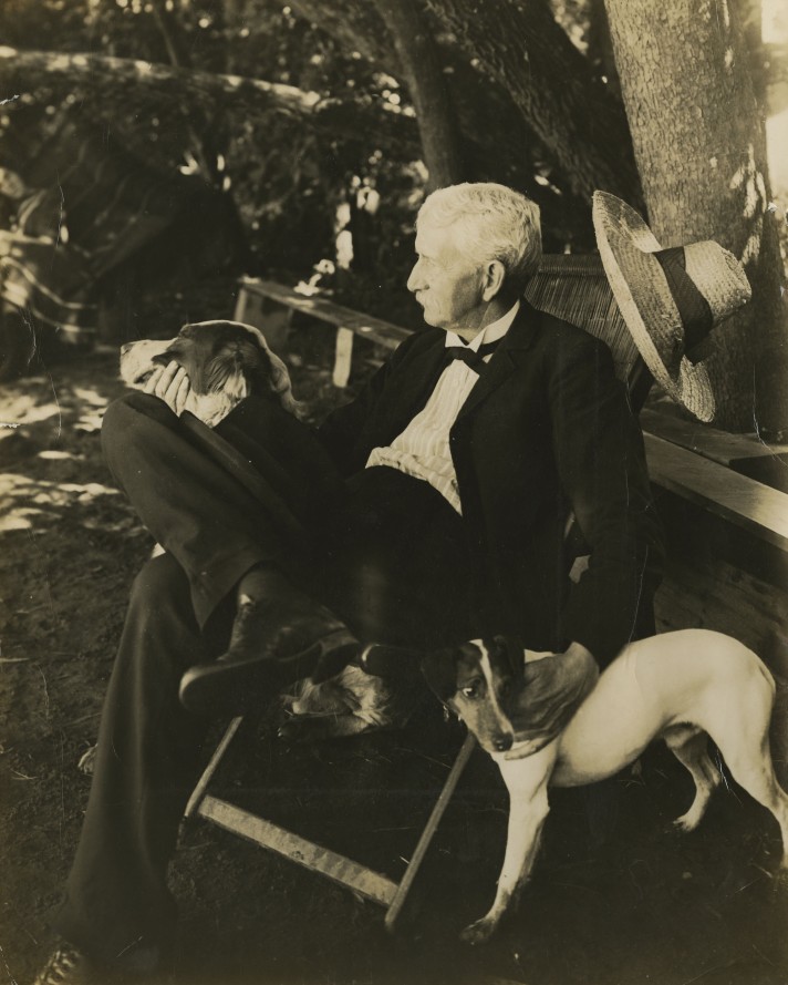 image of Presidnet McBryde outdoors with two dogs